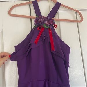 Purple gown with flower and red velvet bow